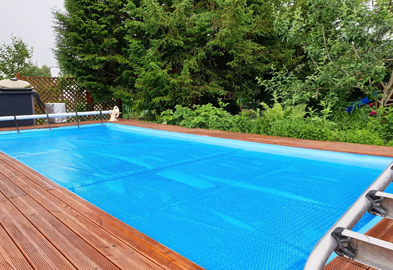 A swimming pool with a cover over it for winter.