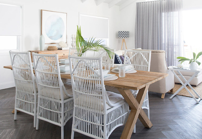 Living room with dining table and layered window furnishings.