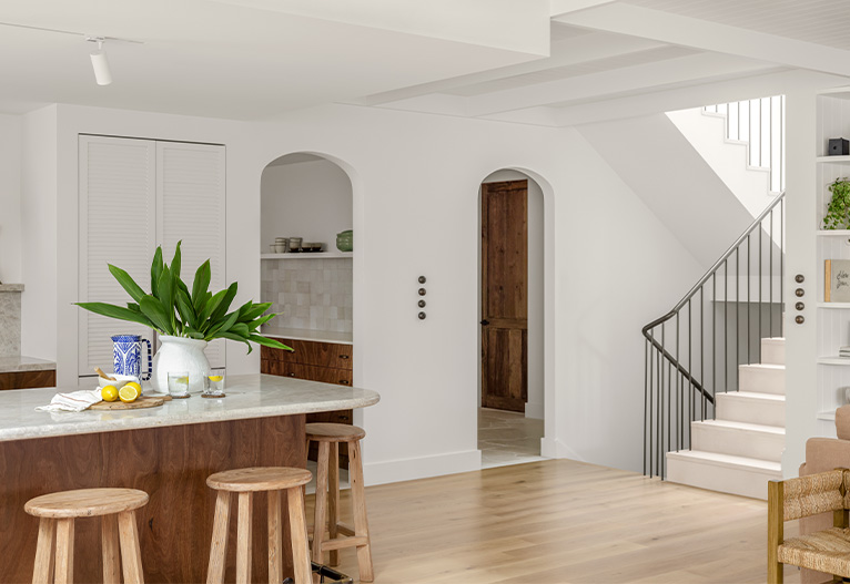 Maybe Forever kitchen with arched doorways and staircase.