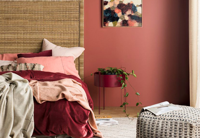 Bedroom with striking red walls.