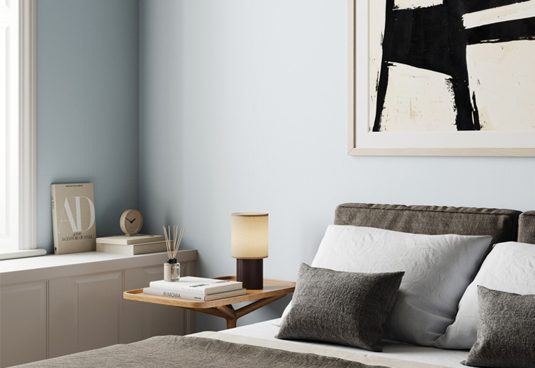 Bedroom with faded blue walls.