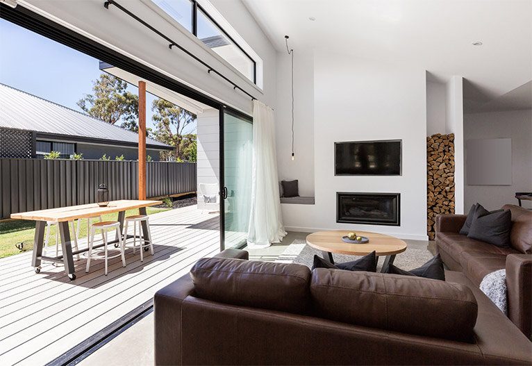 Lounge room with large glass doors to small yard.