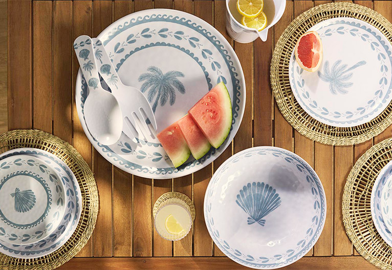 Big W tropical blue dinner and side plates on an outdoor table.