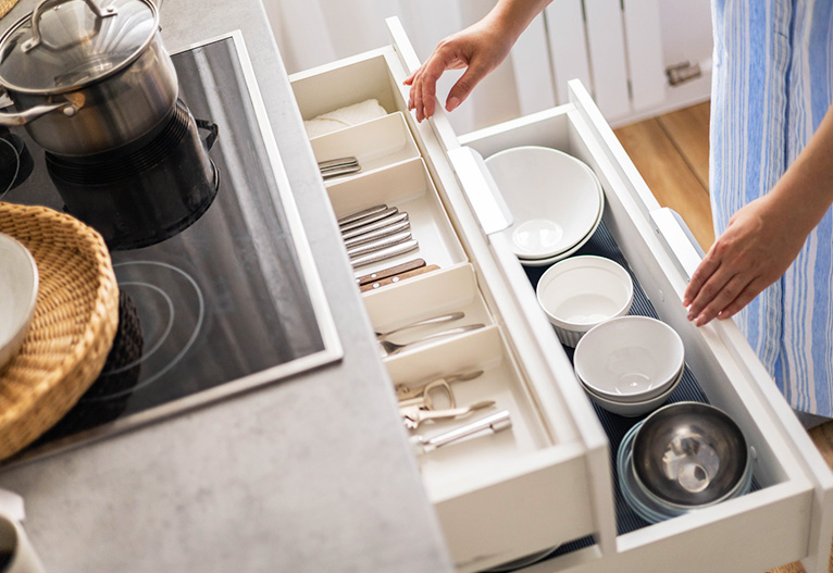 Person opening their kitchen drawers.