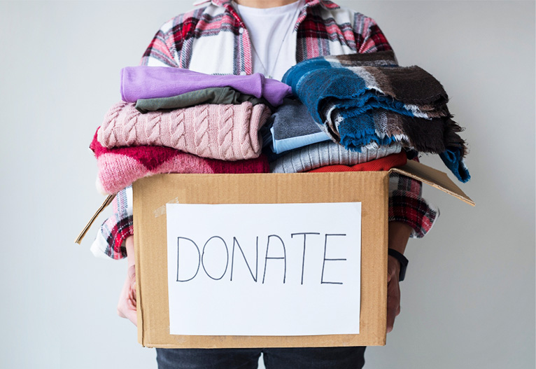 Person holding a box labelled 'donate'.