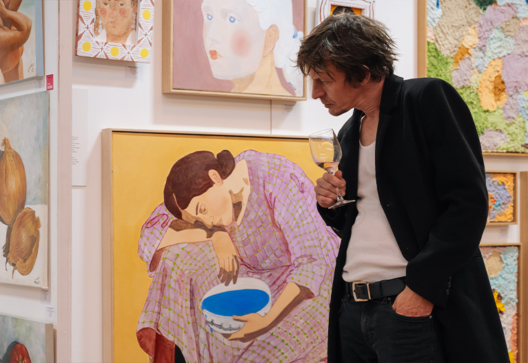 Man looking at art at the Melbourne Affordable Art Fair.
