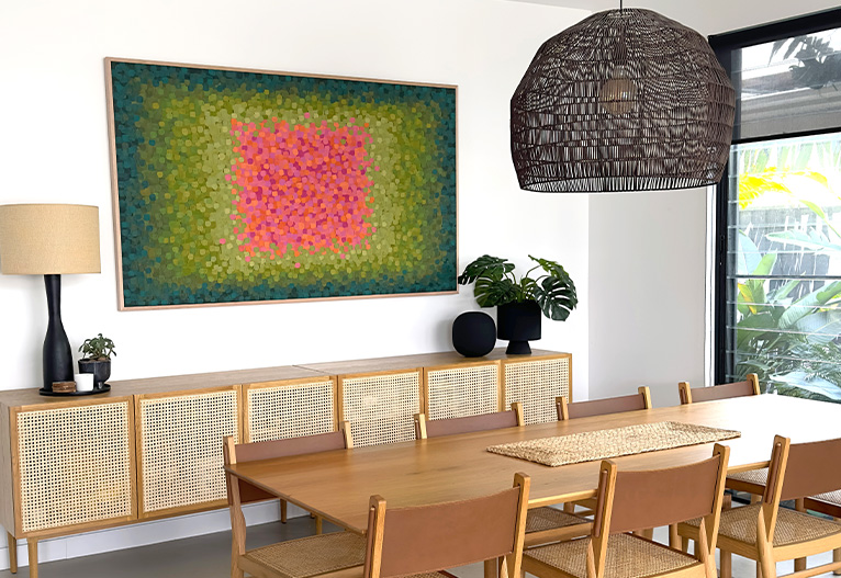 Tania Blanchard artwork on a wall above a buffet.