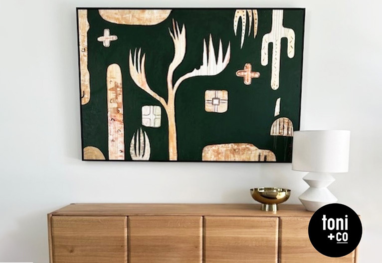 Wall art above a timber buffet.
