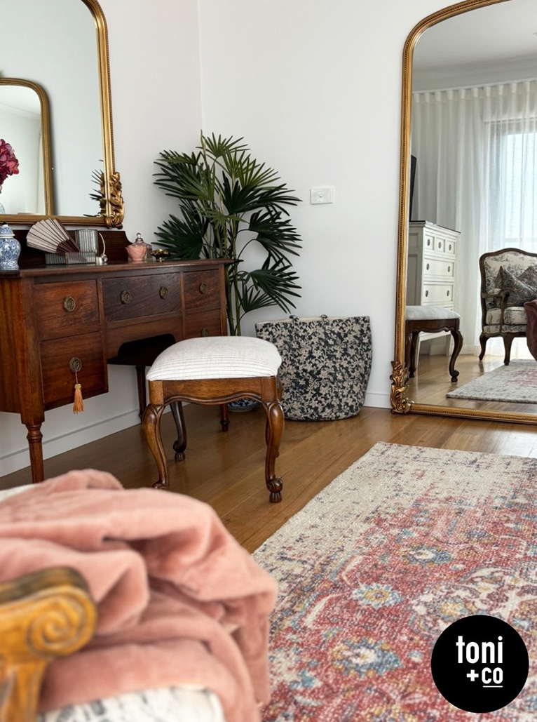 Bedroom vanity with large mirrors.