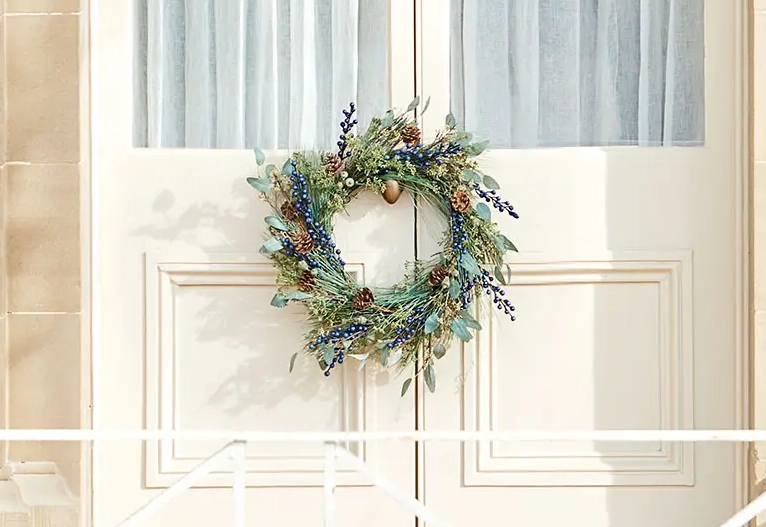 Australian-themed Christmas wreath hanging on an external door handle.