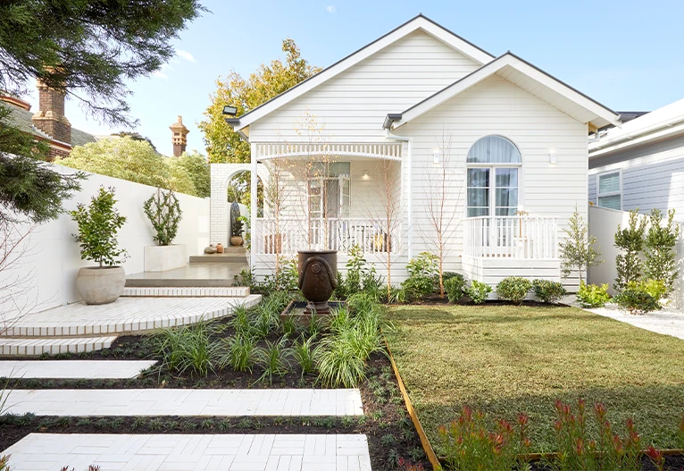 Front garden of a white weatherboard house.