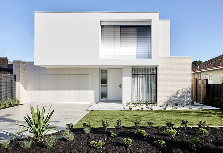 Modern white home street view.
