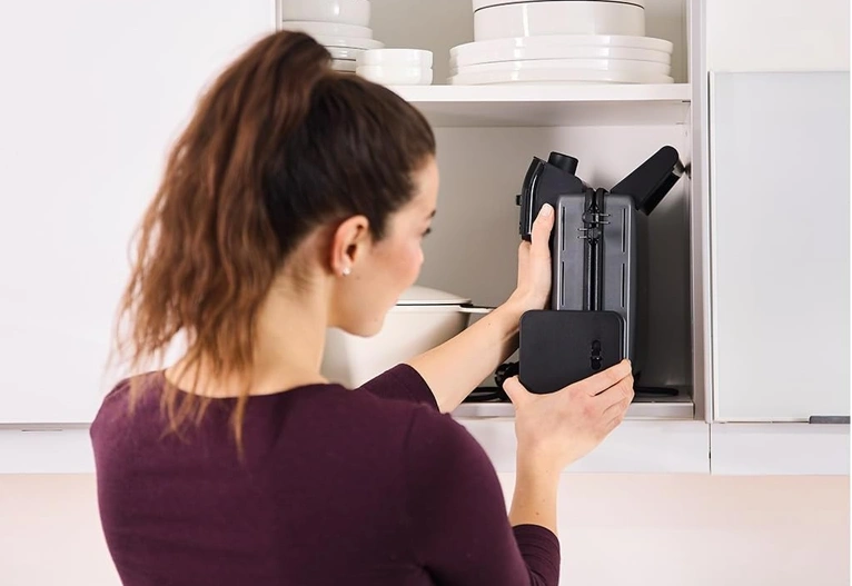 Woman putting away the Braun MultiGrill appliance.